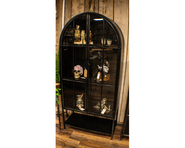 Arched tall slim glass fronted black metal storage display cabinet.