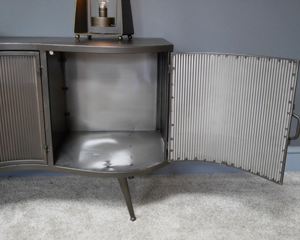 Large curvy ribbed metal storage cabinet